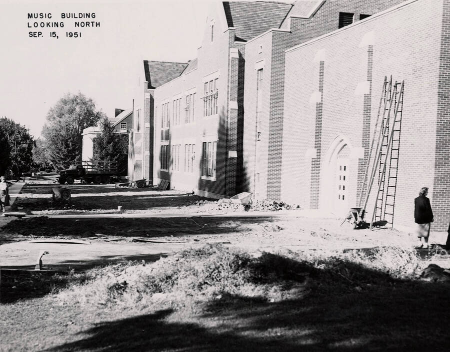 September 15, 1951 photograph of the Music Building under construction. Students in the foreground. [PG1_117-28b]