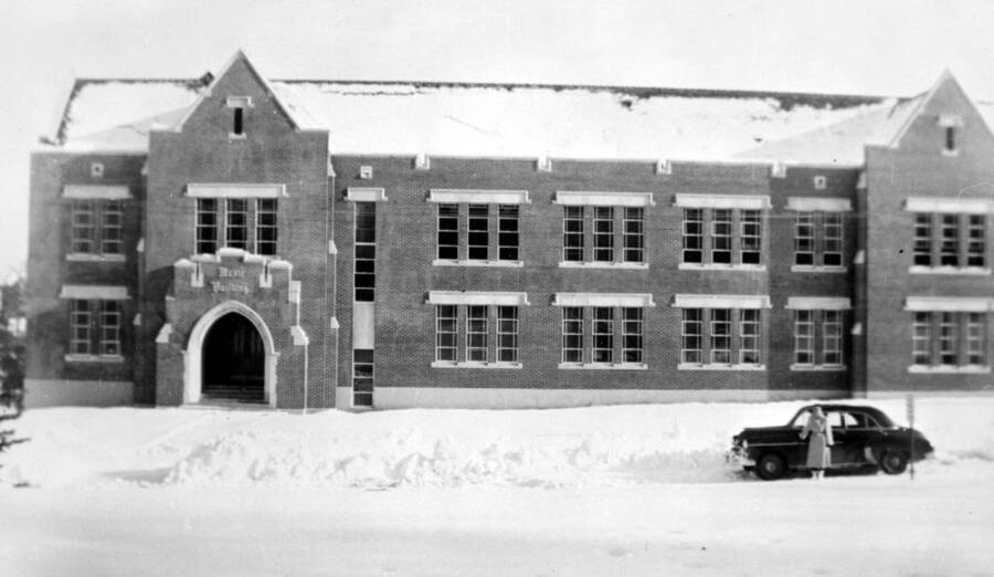 1960 photograph of the Music Building. Student and automobile in foreground. [PG1_117-33]
