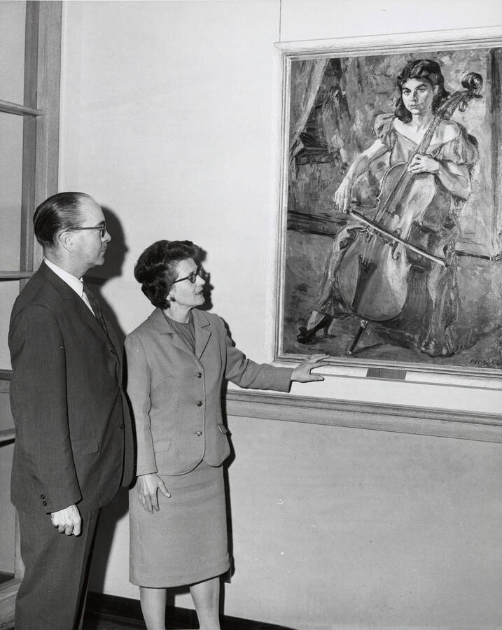 1964 photograph of a painting in the Music Building. Hall Macklin and unidentified woman view the painting. Donor: Publications Dept. [PG1_117-08]