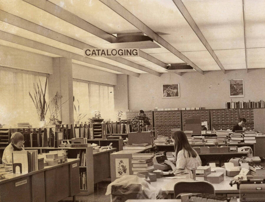 1978 photograph of the Library. Left to right: Henrietta Pew, Karen Eckert, Judith Faulkner in the Technical Services department with card catalog in background. [PG1_122-083b]