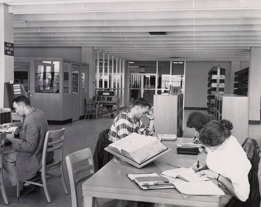 1957 photograph of the Library. Several students study in the foreground. [PG1_122-041]