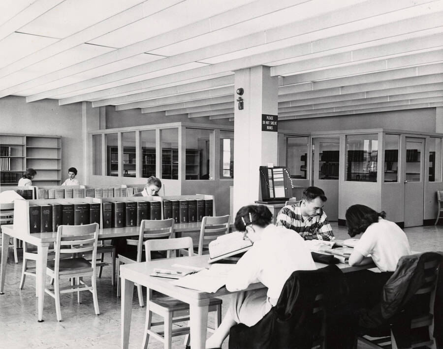 1957 photograph of the Library. Several students study in the foreground. [PG1_122-042]