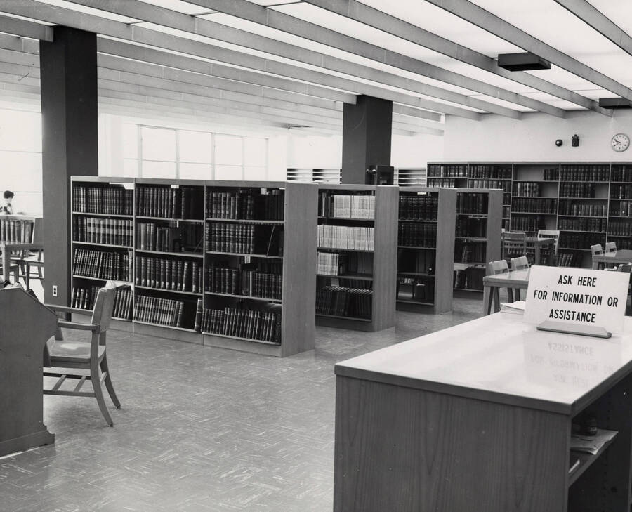 1957 photograph of the Library. Reference area with stacks in foreground. [PG1_122-052]