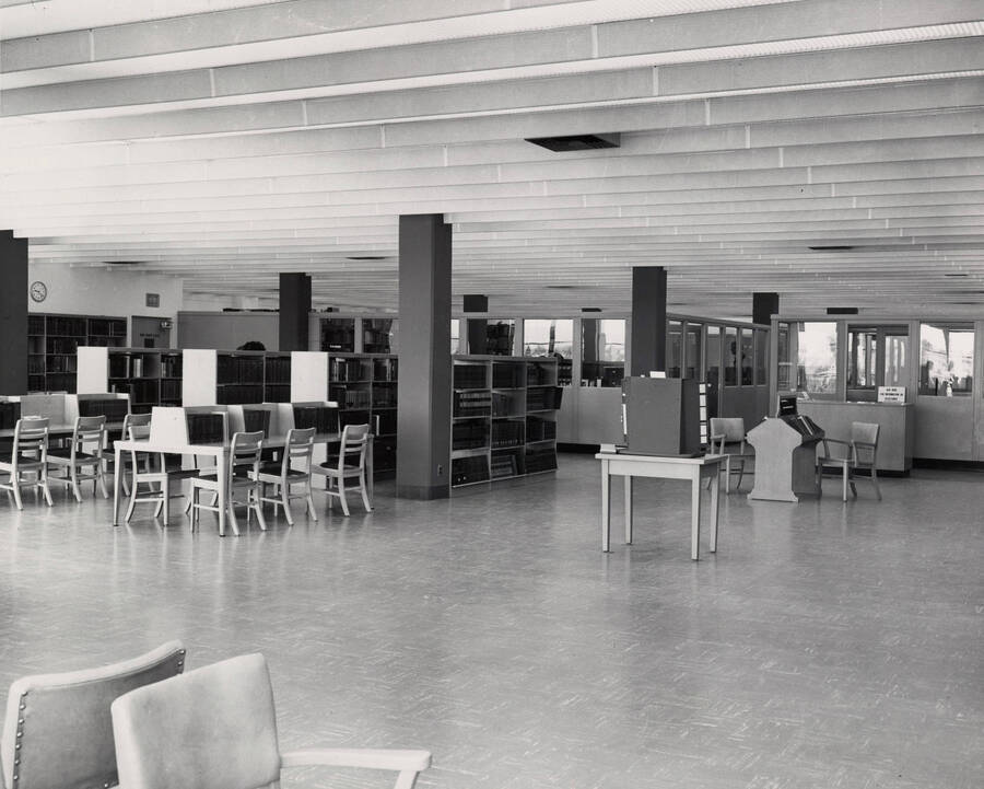 1957 photograph of the Library. Reference area with stacks to the left. [PG1_122-053]