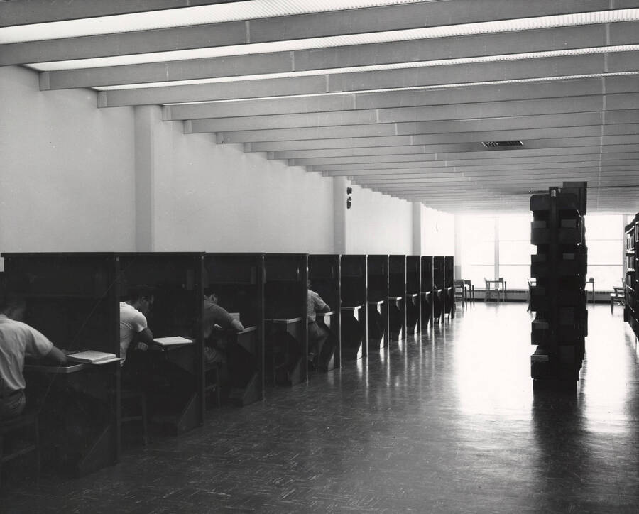 1957 photograph of the Library. Students at study carrels to the left. [PG1_122-054]