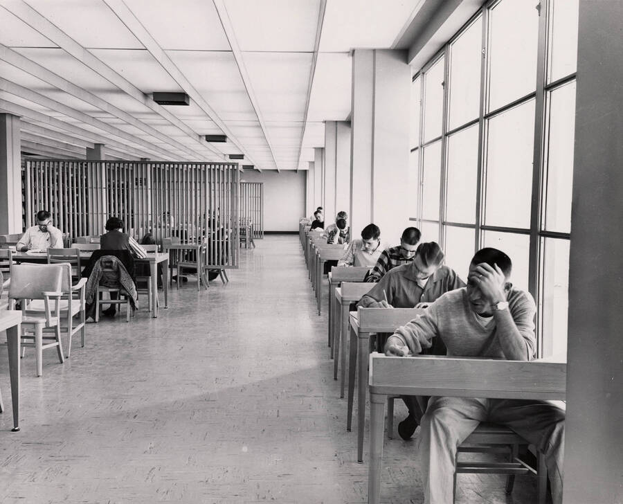 1957 photograph of the Library. Students studying at tables. [PG1_122-059]