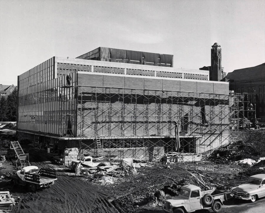 1957 photograph of the Library under construction. Automobiles in foreground. Donor: Publications Dept. [PG1_122-067]