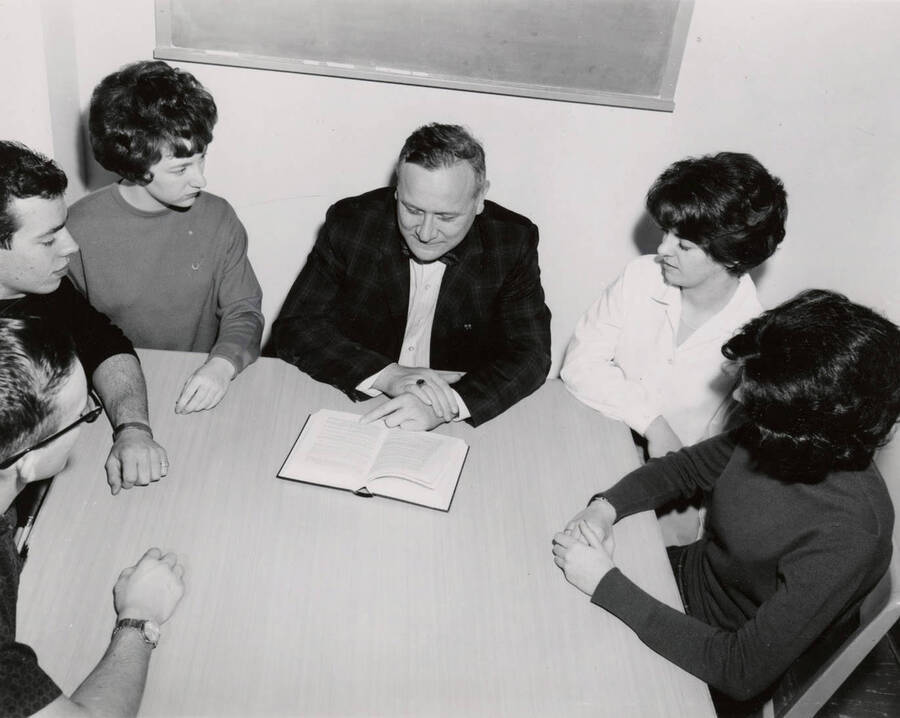 1957 photograph of Library. Charles Webbert with students in seminar room. Donor: Publications Dept. [PG1_122-074]
