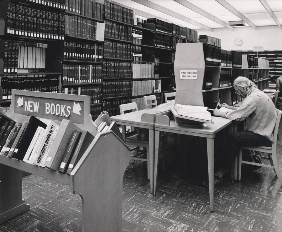 October 1, 1982 photograph of the Library. A student studies near index stacks. [PG1_122-096]