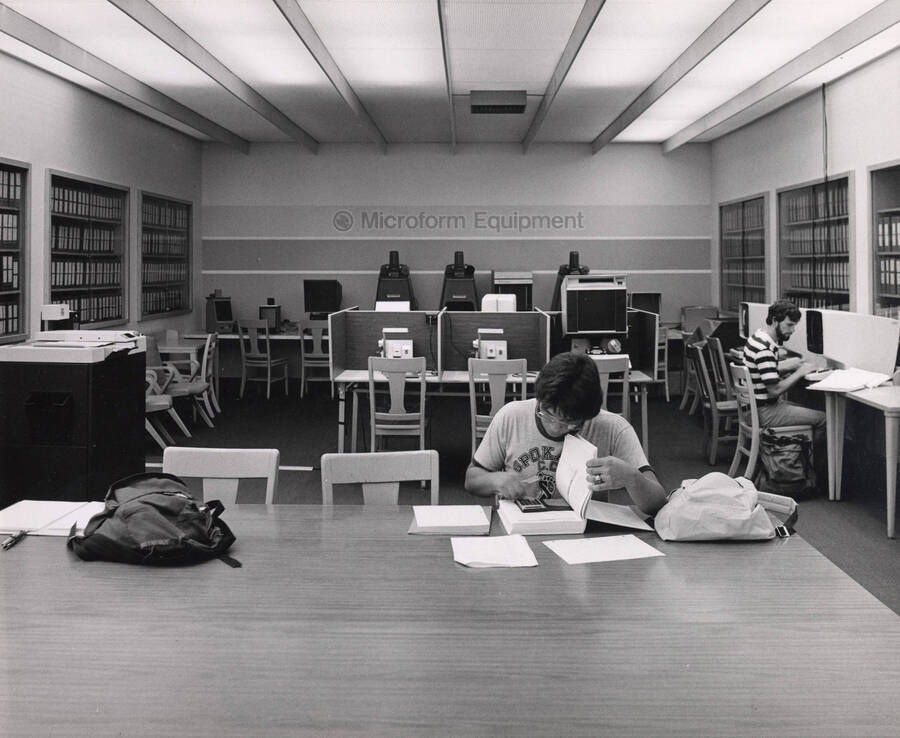 October 1, 1982 photograph of the Library. Students study in the microform equipment area. [PG1_122-097]