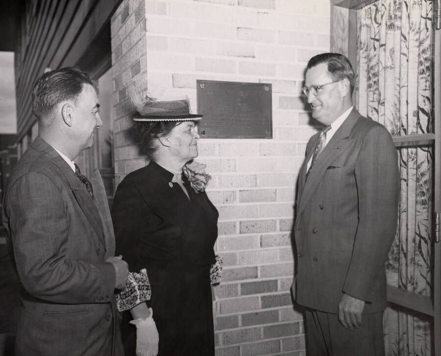 1953 photograph of the Ethel Steel House dedication ceremony. Left to right: Robert Greene, Ethel Steel, J. Buchanan next to dedicatory plaque. [PG1_124-04]