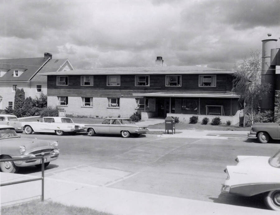 1954 photograph of the Ethel Steel House. Automobiles in foreground. [PG1_124-08]