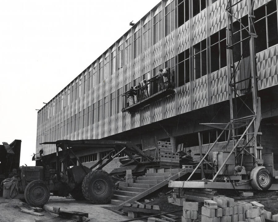 1962 photograph of the Mines Building under construction. Construction workers on the side of the building. Donor: Publications Dept. [PG1_125-12]