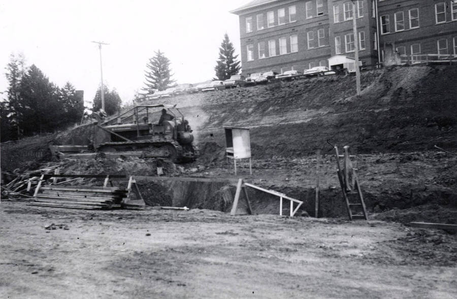 1960 photograph of the Mines Building under construction. Construction workers on equipment in foreground. Donor: College of Mines. [PG1_125-02]