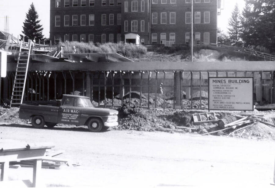 1960 photograph of the Mines Building under construction. Automobile in foreground. Donor: College of Mines. [PG1_125-05]