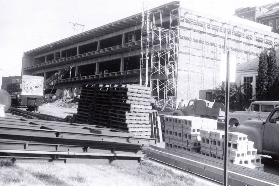 1960 photograph of the Mines Building under construction. Automobiles in foreground. Donor: College of Mines. [PG1_125-09]