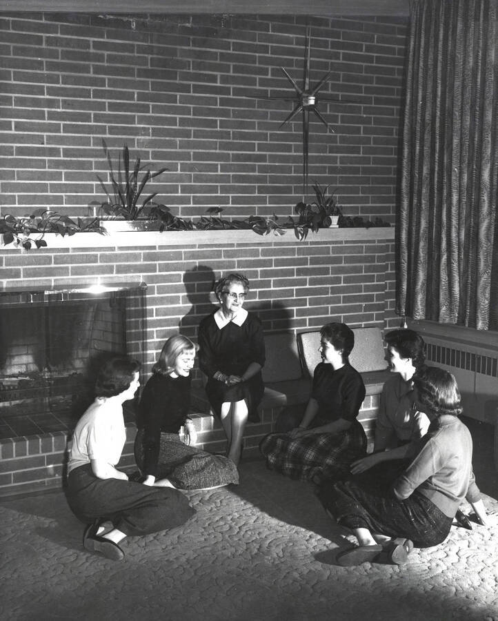 1958 photograph of Permeal J French House. A group of women sit in the living room. [PG1_126-01]