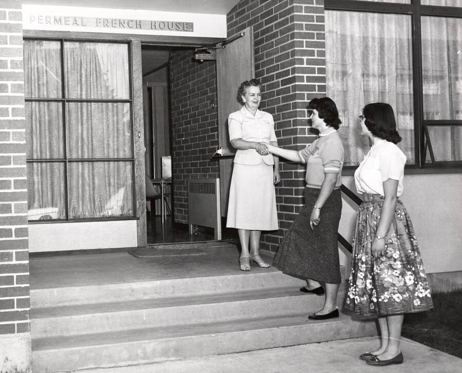 1955 photograph of the Permeal J French House. Left to right: Harriet Cummerford, Permeal French House Hostess, Charlotte Aldus, Lois Seubert. Donor: Publications Dept. [PG1_126-05]
