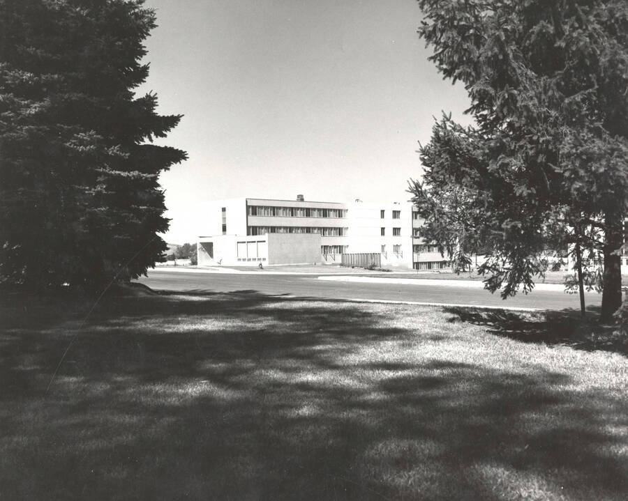 1961 photograph of Shoup Hall. Trees in foreground. [PG1_127-01]