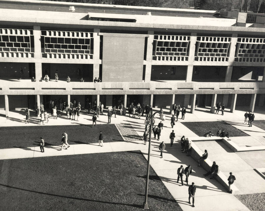 1965 photograph of University Classroom Center. Many students in front of building. [PG1_128-15]