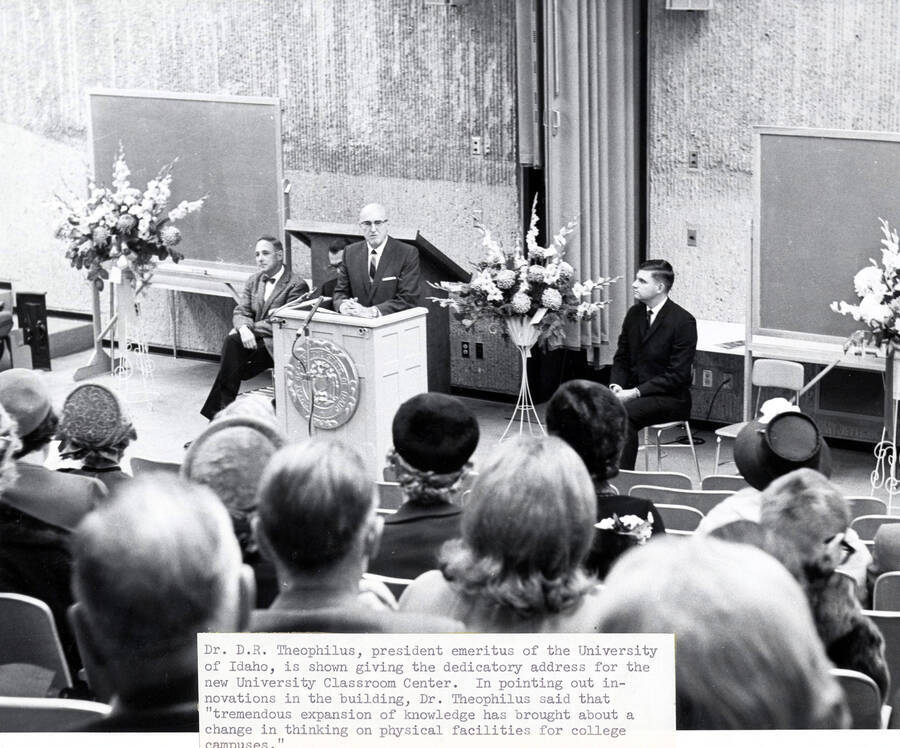 1965 photograph of the University Classroom Center dedication ceremony. D.R. Theophilus at lectern. Donor: Publications Dept. [PG1_128-04]