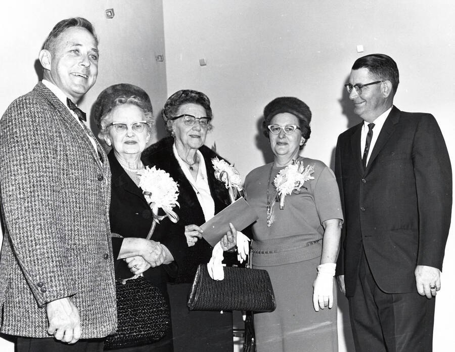 November 13, 1965 photograph of the dedication ceremony of the Willey Wing of the Wallace Residence Center. Left to right: E.W. Hartung, Mrs. J.E. Graham, Louise Carter, Mr. and Mrs. Harold Snow. [PG1_129-b]