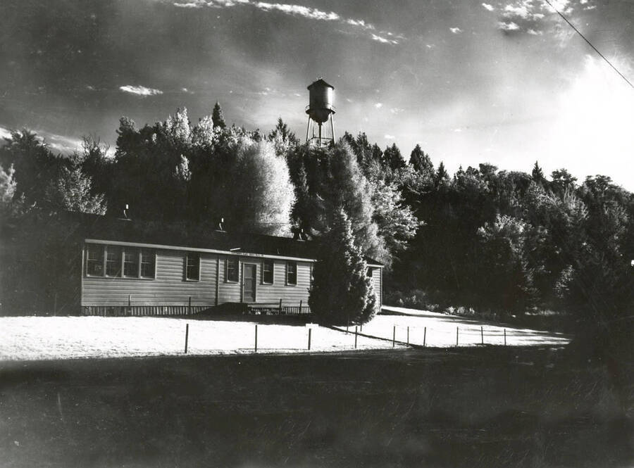 1952 photograph of the Communications (Radio-TV) Building. Water tower in background. [PG1_130-01]
