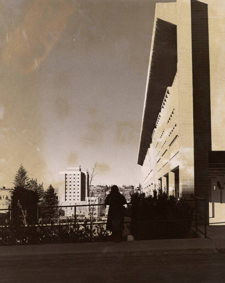 1969 photograph of the Donald R Theophilus Residence Hall. Student in the foreground, the University Classroom Center to the right. [PG1_134-14]