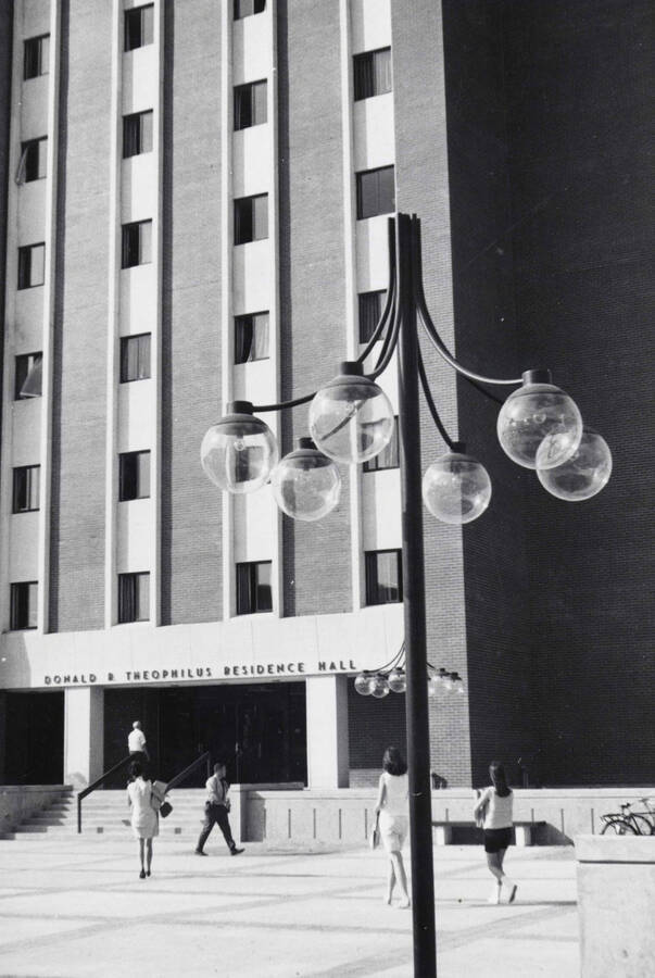 1969 photograph of the Donald R Theophilus Residence Hall. Students in foreground. Donor: Publications Dept. [PG1_134-04]