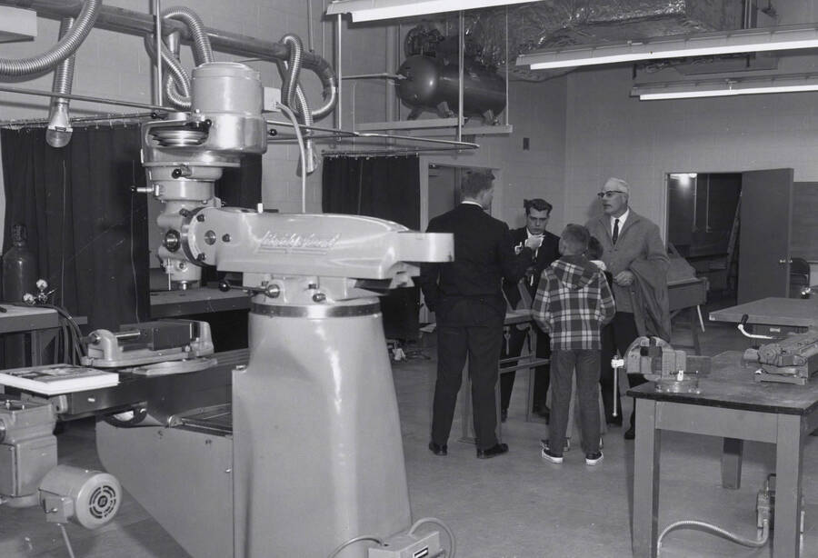 1968 photograph of the Industrial Education Building. Group of people in background, equipment in foreground. Donor: Publications Dept. [PG1_136-01]