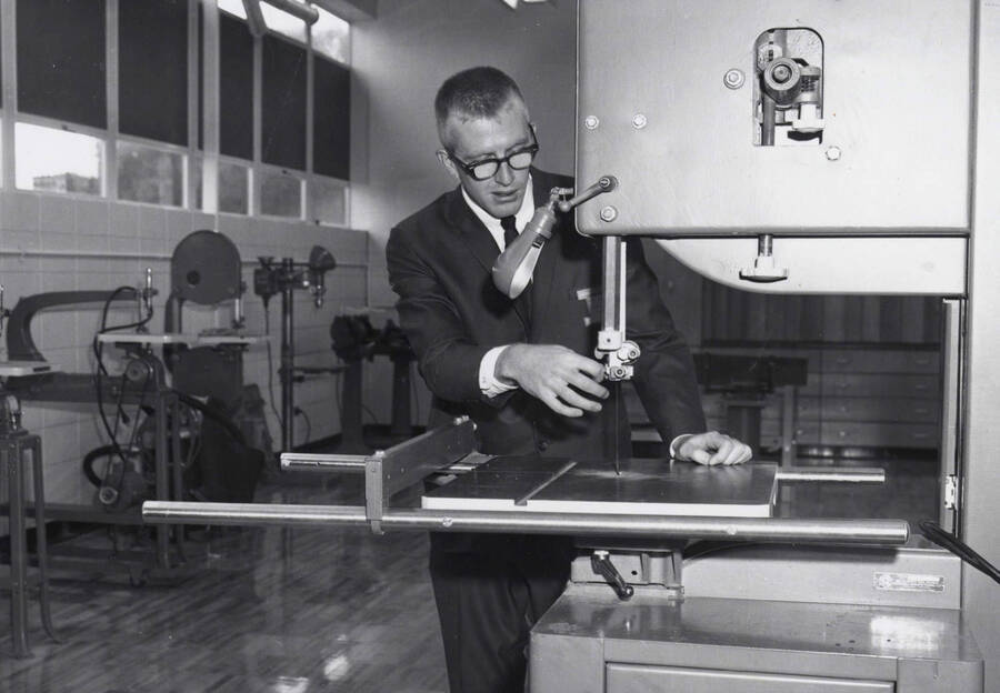 1968 photograph of the Industrial Education Building. A man demonstrates a machine. Donor: Publications Dept. [PG1_136-02]
