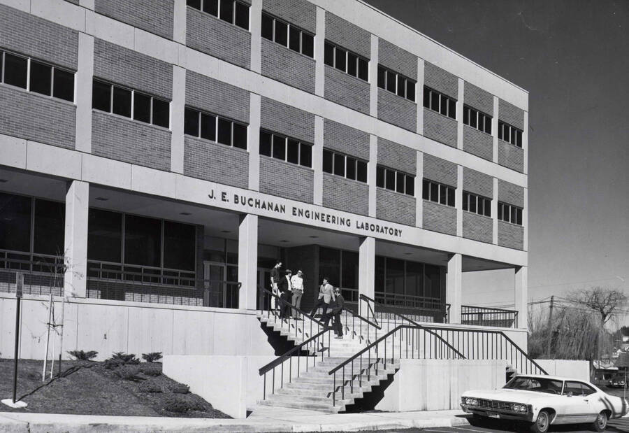 1968 photograph of the Buchanan Engineering Laboratory. Students and an automobile in foreground. Donor: Publications Dept. [PG1_137-04]