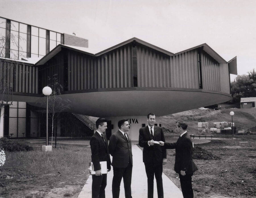 1969 photograph of the Education Building. Left to right: Unidentified, Forrest E. Sears, Everett Samuelson, Edmund Chavez. Donor: Publications Dept.. [PG1_139-01]