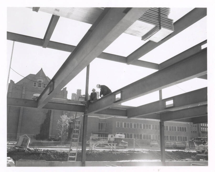1968 photograph of the Education Building under construction. Construction workers in foreground. [PG1_139-13]