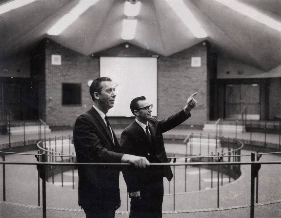1969 photograph of the Education Building. Everett Samuelson and Thomas O. Bell inspect the interior of the Kiva. Donor: Publications Dept. [PG1_139-02]