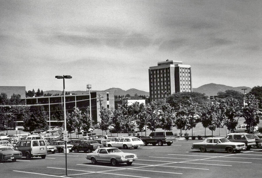 1970 photograph of Wallace Residence Center and Theophilus Tower on the University of Idaho campus. Automobiles in foreground. [PG1_141-14]