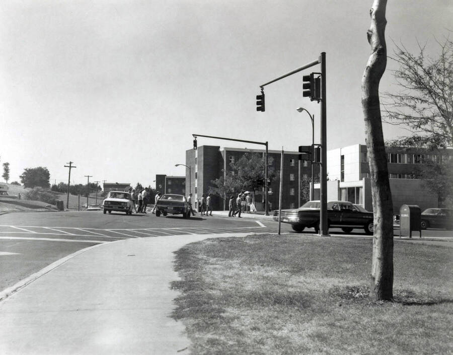 1970 photograph of the Wallace Residence Center. Students and automobiles in foreground. [PG1_141-19]