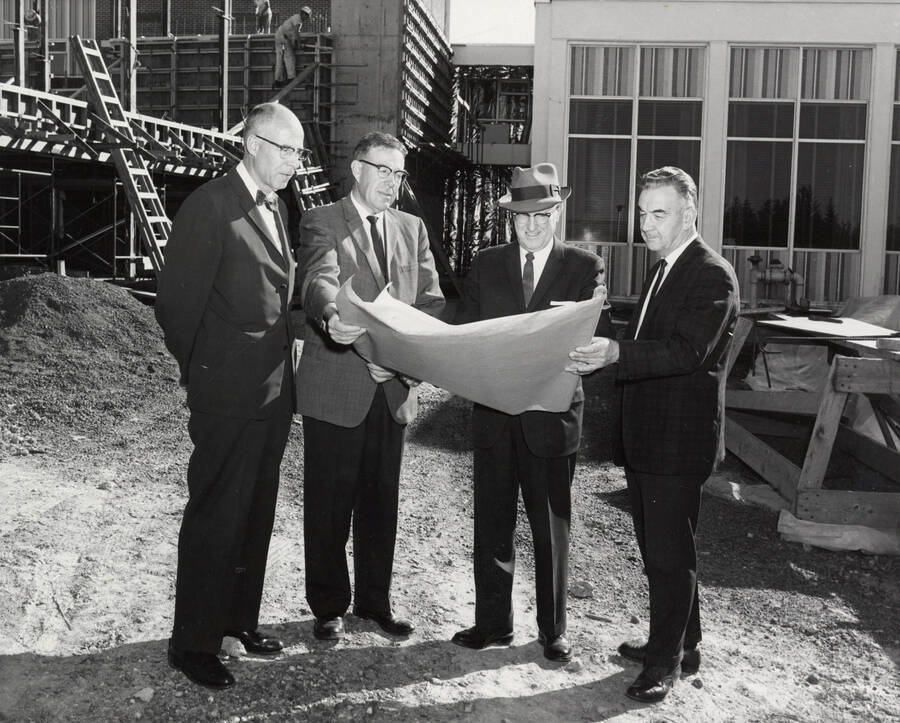 1963 photograph of the Wallace Residence Center under construction. Left to Right: President Theophilus, Kenneth A. Dick, Elvin Hampton, Robert F. Greene. Donor: Publications Dept. [PG1_141-03]