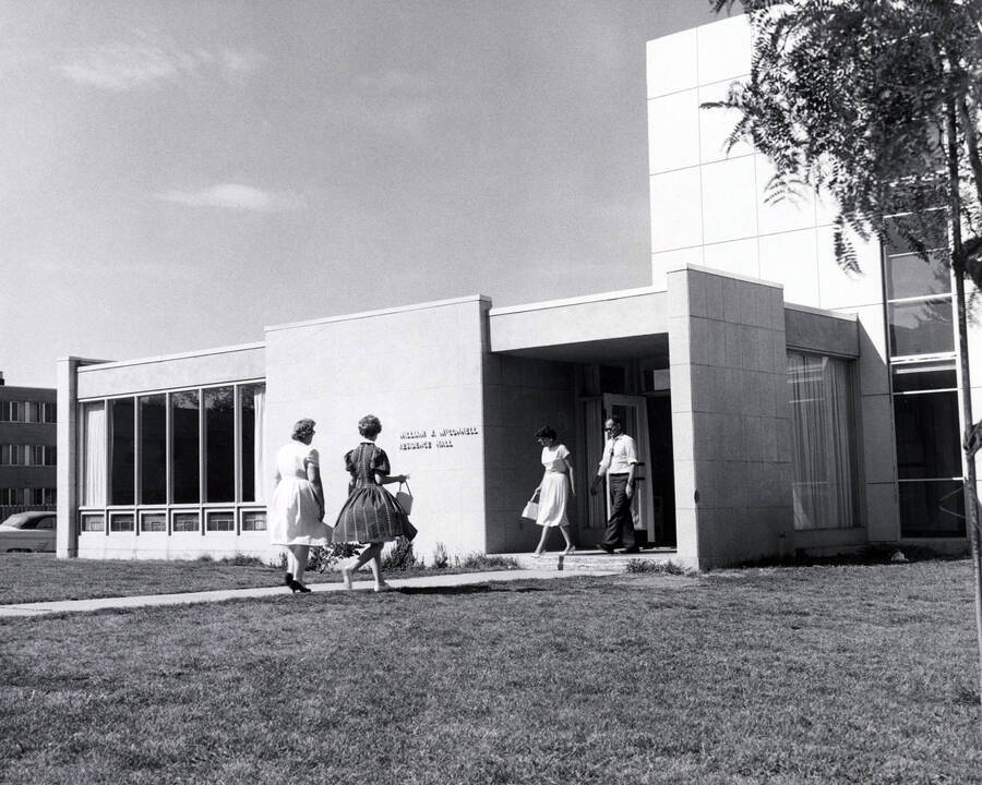 1960 photograph of the William J. McConnell Residence Hall. Students in foreground. Donor: Publications Dept. [PG1_142-01]