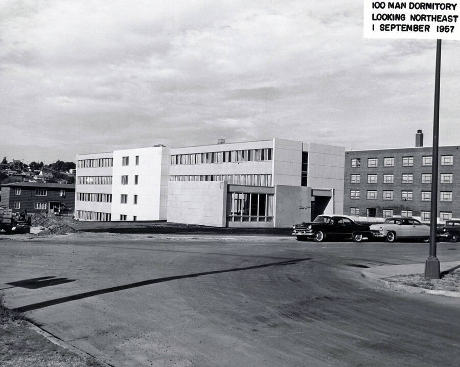 September 1, 1957 photograph of the William J. McConnell Residence Hall. Automobiles in foreground. Donor: Publications Dept. [PG1_142-02]