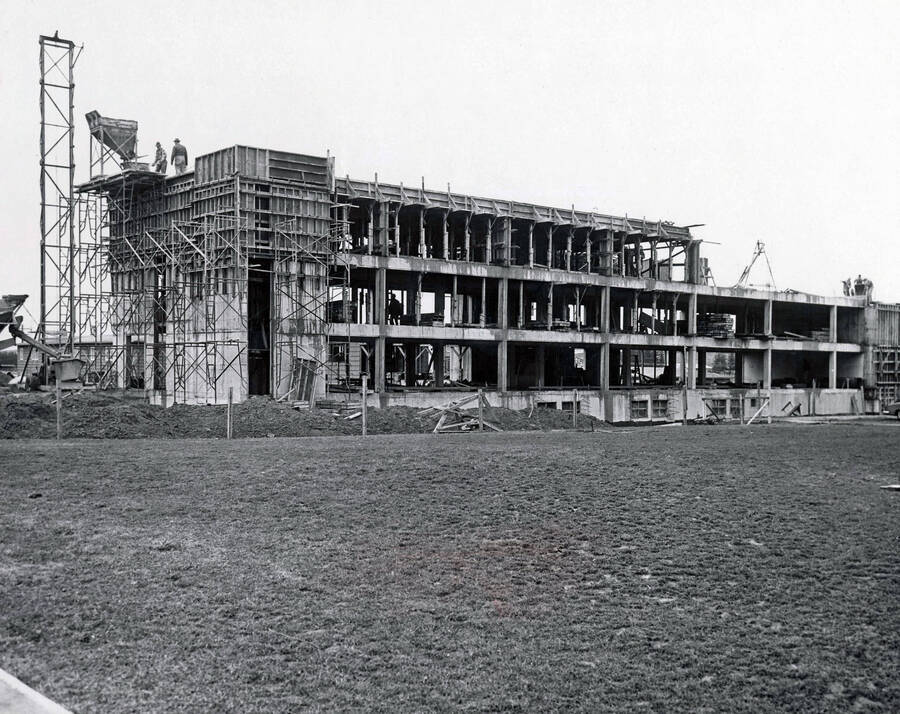 1957 photograph of the William J. McConnell Residence Hall under construction. Construction workers visible on top of structure. Donor: Publications Dept. [PG1_142-04]