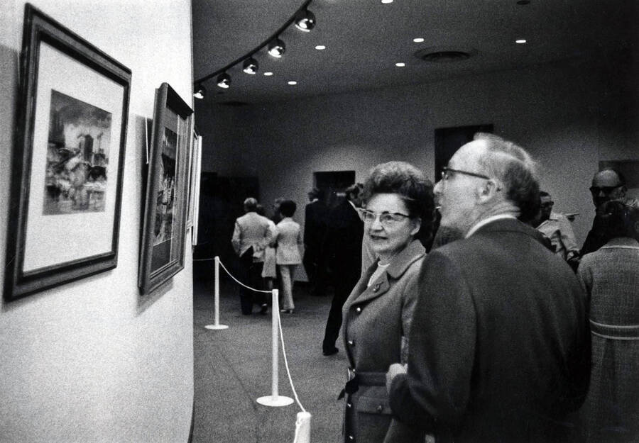 1974 photograph of the Hartung Theatre. Mr. And Mrs. G.E. McProud view the Alf Dunn exhibit in the lobby. [PG1_145-11]
