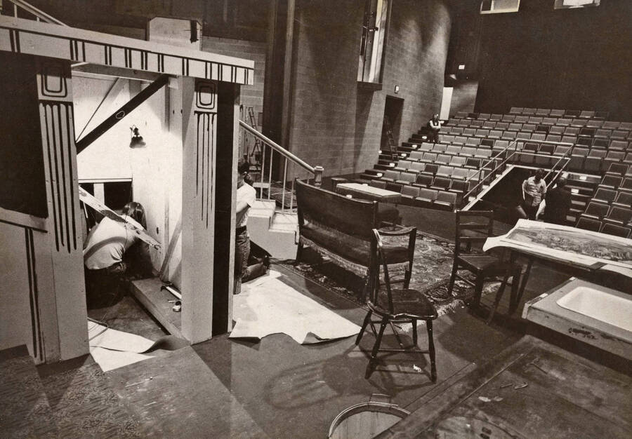 1975 photograph of Hartung Theatre. Students build the set on stage. [PG1_145-14a]