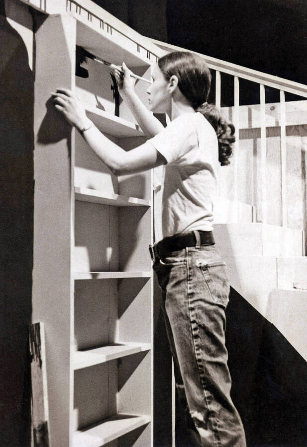 1975 photograph of Hartung Theatre. Students build the set on stage. [PG1_145-14b]