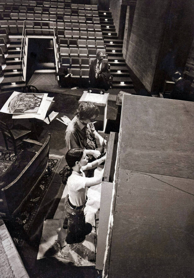 1975 photograph of Hartung Theatre. Students build the set on stage. [PG1_145-14c]