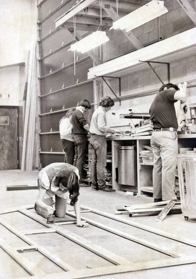 1975 photograph of Hartung Theatre. Students build set elements. [PG1_145-16a]