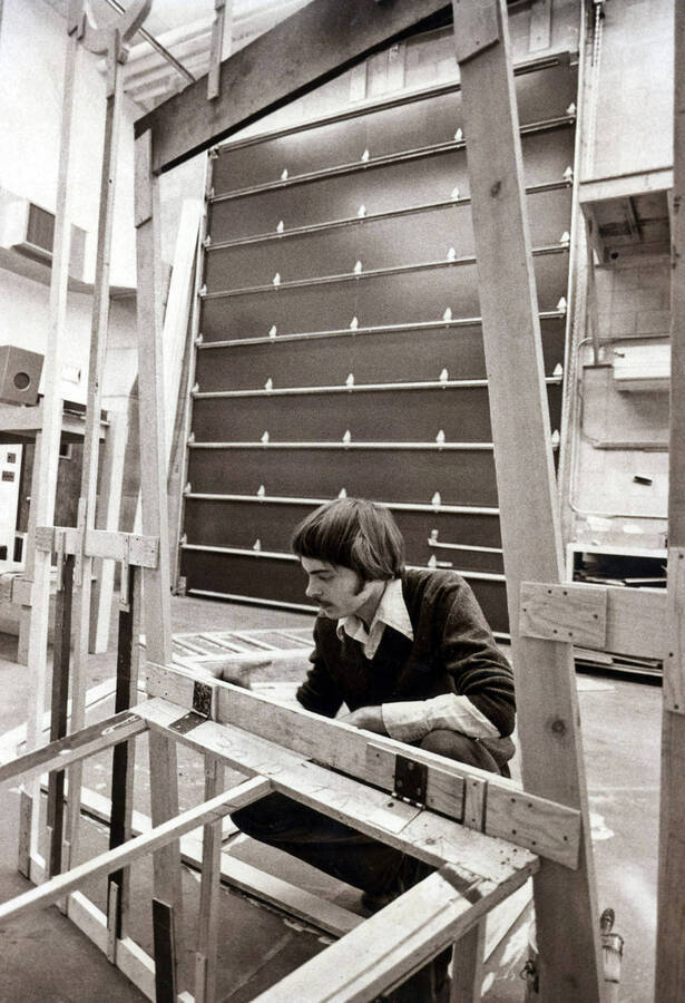1975 photograph of Hartung Theatre. Students build set elements. [PG1_145-16b]