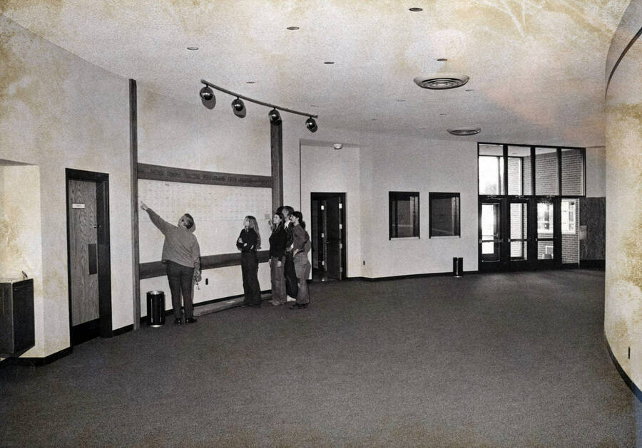1974 photograph of the Hartung Theatre. Students stand in the lobby. [PG1_145-09]