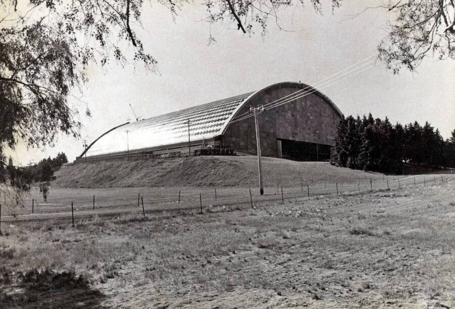 1975 photograph of the Kibbie-ASUI Activity Center under construction. View from a neighboring field. [PG1_147-19]