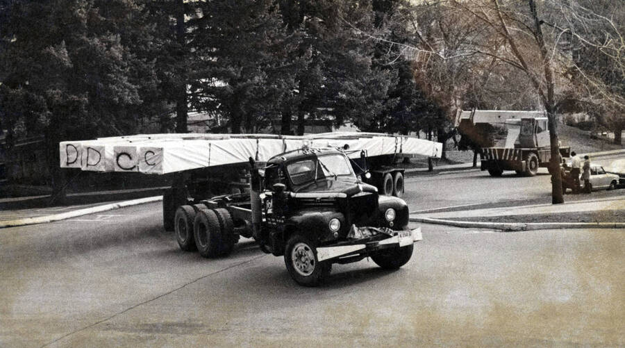 1971 photograph of the Kibbie-ASUI Activity Center under construction. Large truck moves construction equipment. [PG1_147-22]